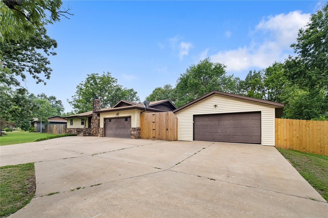 Don't miss this 4 bed, 2 bath home in Rogers just outside city limits. The .77 acre setting with mature trees is perfect for those who want to feel like they are in the middle of nowhere, yet want the convenience of being close to town. Minutes from restaurants and shopping in Downtown Rogers, and a short drive to Bentonville with its world famous museums and Bella Vista with this now famous bike trails. You can park your cars in the attached 2 car garage, and use the nearly 800 sq ft shop for your hobby or to store your really expensive toys (boats, trailers, side-by-sides, etc). The back yard is fenced, and has an area for entertaining.