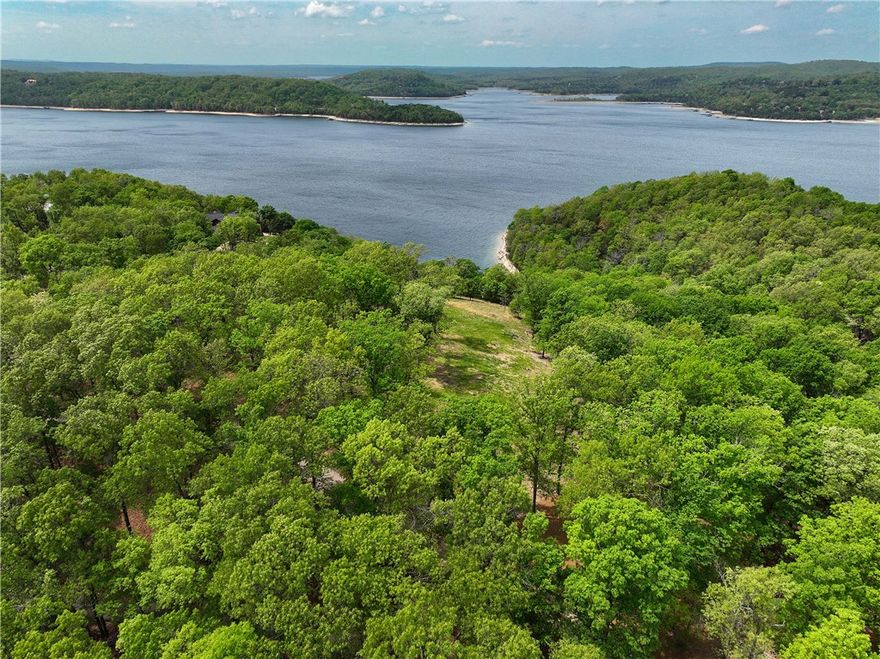 This Beaver Lake lake front lot offers a truly unbelievable view of the main lake channel paired with a rare, large flat building area—an exceptional combination that’s hard to find. One of the last premier lake view lots in Point Mirage, it’s perfectly positioned for a custom home with expansive, million-dollar views while still allowing privacy from the street.
Buyers are drawn to Beaver Lake for its clear water, boating, fishing, and peaceful natural setting—making it the perfect place to build a primary residence or weekend escape. Located in a desirable subdivision with paved roads, large lots, and upscale homes, and just minutes from Starkey Marina.
Convenient for quick getaways from Fayetteville, Rogers, and Bentonville, this is a rare opportunity to build your dream home in one of Northwest Arkansas’ most sought-after lake communities. Schedule a time to walk the property and experience the amazing view for yourself!