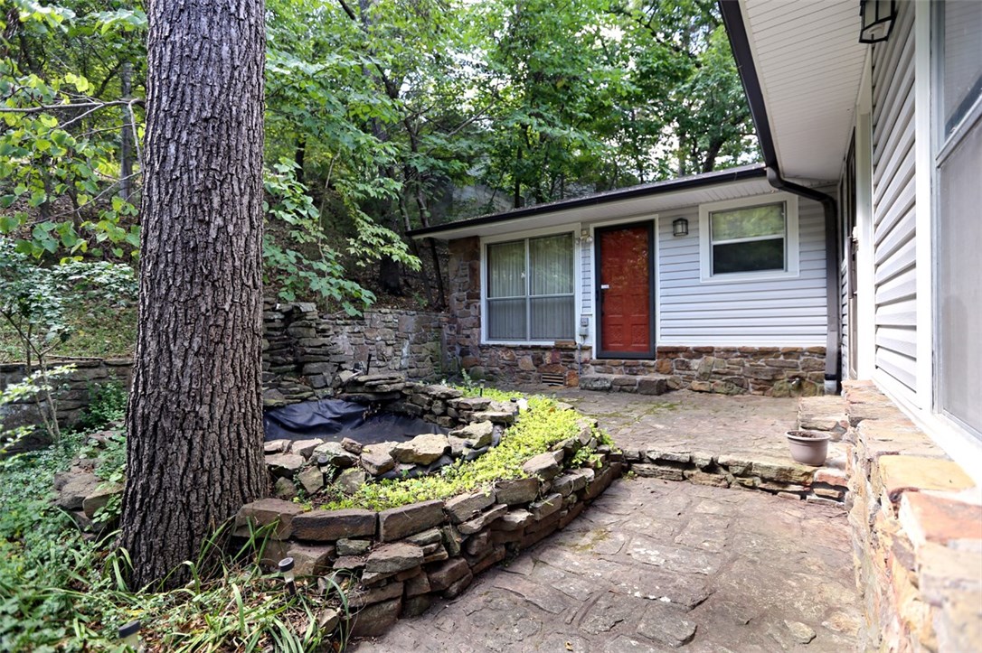 This is a fantastic opportunity to own a custom built home, walking distance to Beaver Lake!! This is a 2 story home with a sun room and a walk out deck on the top level. Outside you will find 1.5 acres of partially open yard mixed with large beautiful trees and a lake view. It is truly one of a kind! You will be happy to know that the roof is less than 2 years old! Private and ready for your custom touches! Book your appointment now!