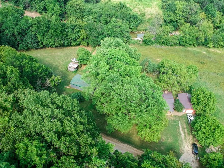 Looking for that "Magnolia" Farmhouse, well look no more this well cared for Farm Home has privacy, close to the national forest and Cove Creek yet only minutes to Prairie Grove. Amazing screened in porch for the adults to enjoy while watching the kids roam and play in the backyard. Do we have your attention, now for the 24 x 38 workshop/ barn,  what a dream at this price point! You won't be disappointed, pictures do not do this one justice. Walk in to that cozy "I feel at home feeling"