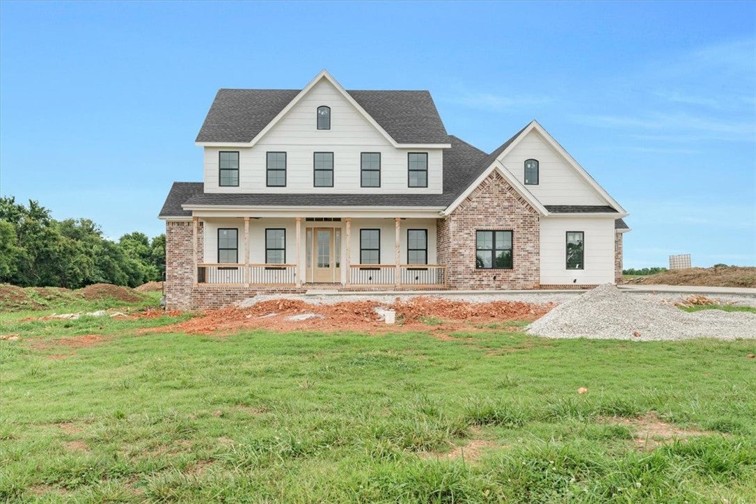 Newly constructed residence featuring white siding