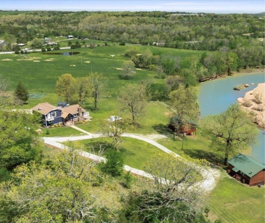 Stunning Riverfront Retreat on the Kings River with over 800 feet of private river frontage--an unbeatable opportunity to own a piece of paradise. This unique 15.62-acre oasis offers endless possibilities with a beautifully updated 5 bed, 3.5 bath, 3,720 sq ft main house, plus two fully remodeled, furnished 620 sq ft log cabins currently thriving as short-term rentals. Perfect for multigenerational living, a sustainable homestead, or turn-key vacation business. Enjoy clean, pure well water, a whole-home generator, and 15+ mature fruit trees blending self-sufficiency & comfort. Features include a barn with stables, private shooting range, pickleball court, and abundant wildlife for on-property hunting. Fish from your backyard on the pristine Kings River, known for its beauty and smallmouth bass. Just 20 minutes to Eureka Springs, 12 to Eagle Rock Marina on Table Rock Lake, and 20 to Dogwood Canyon. Whether you're after a peaceful retreat, high-performing investment, or forever family compound—this one has it all.