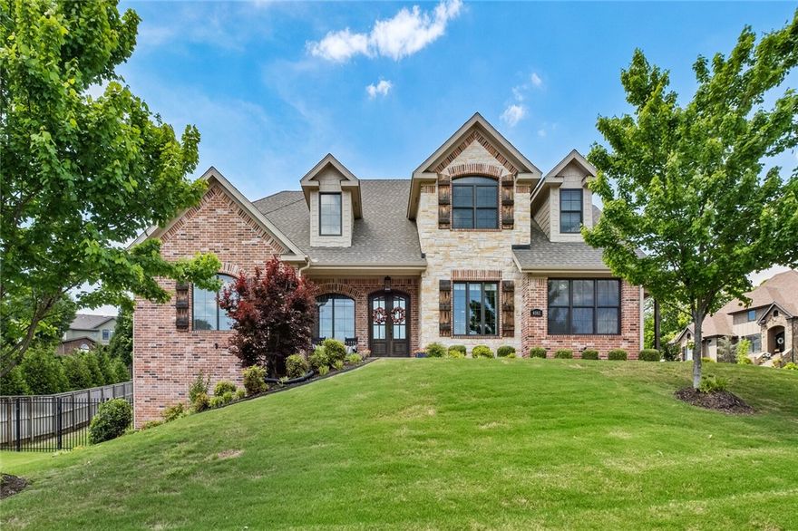 Gorgeous custom 5-bedroom, 4.5-bath home offering 4,606 sq ft of thoughtfully designed living space on a 0.48-acre corner lot in desirable Heritage Hills. Conveniently located off Don Tyson Pkwy with easy access to I-49, Arkansas Children’s Hospital, Tyson & Shiloh Christian Schools. With a 3-car garage & exceptional curb appeal, this home is sure to impress. The chef’s kitchen features custom cabinetry, a massive 3cm quartz island/bar & sleek quartz countertops. The open-concept main living area showcases hardwood flooring & built-in shelving flanking a gas fireplace. Downstairs offers a versatile media room or private in-law suite with kitchenette, full bath & separate entrance. The luxurious primary suite is privately located on the main level. Upstairs includes four additional bedrooms, a bonus room & ample space for guests or a growing family. Also includes central vacuum, intercom & covered patio overlooking a private backyard. This home has it all—space, style & smart design throughout!