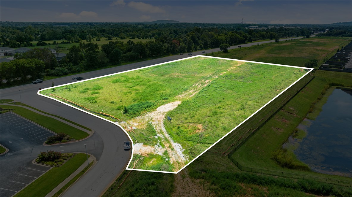 This 3.87-acre parcel offers a prime development opportunity at the intersection of Pleasant Grove Road and Highway 71 Business, where more than 30,000 vehicles pass daily. Located on the Rogers–Lowell border in one of Northwest Arkansas’s fastest-growing commercial corridors, the property provides excellent visibility, access, and exposure for a variety of commercial uses. The site features direct street frontage with utilities available at the property line and established detention to the west, allowing for significant savings on upfront development costs and making the parcel ready for immediate development. With multiple configuration possibilities, the property offers flexibility for a wide range of projects and may also be purchased in conjunction with the fully entitled LSD site directly to the south, creating an expanded footprint for larger-scale development.