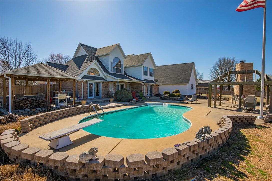 Showstopper with ALL of the extras. Huge 1.17-acre corner lot, RV carport with 30AMP RV power, 2 car oversized attached garage, with a 2 car 900 sq ft detached garage/shop that's perfect for boats, trailers, etc. The backyard features in ground pool, custom landscaping, an outdoor fireplace, hot tub/grill pavilion. Inside, you have a phenomenal layout with 4 bedrooms, 2.5 bathrooms, a formal office, eat-in and formal dining room, and bonus room. Zoned in the desired Springdale School zones (Young Elementary, Hellstern Middle, Central Jr High, and Harber High) and Shaw Park is just down the road. A few miles the interstate is convenient and you're in the heart of Northwest Arkansas. New LVP idownstairs, master shower, and the roof is 5-6 years old.