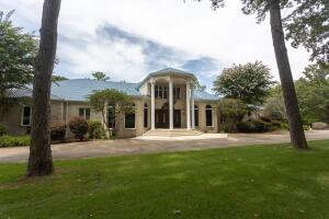This may be your once-in-a-lifetime opportunity to own an iconic piece of Russellville history. Resting on the banks of Lake Dardanelle, this grand home is the epitome of luxury, exclusivity, and a life of peace. This majestic estate spans over 7 acres of park-like, manicured grounds, offering a tranquil retreat that is just moments from town.The grandeur of this stately home is immediately apparent upon entry, with its expansive 15,000 square feet of living space that includes a wonderful indoor pool and spa for year-round enjoyment. Boaters will delight in the private, 2-slip boat dock with lift, offering direct access to the beautiful waters of Lake Dardanelle. The property's own movie theater ensures unforgettable entertainment experiences to enjoy in the comfort of your own home.