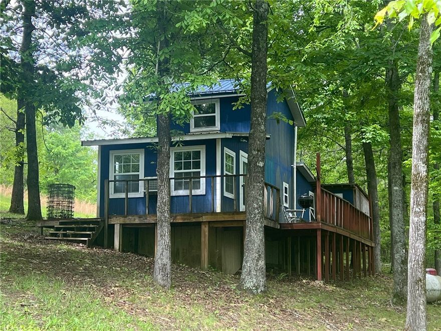 Cabin and 14.76 acres in the Marble Falls area of Newton County, less than a mile from the old Dogpatch and close to Hwy 7 but far enough away to feel secluded and private. With a little TLC this cabin would make a nice rental or getaway. Property has a drilled well and plenty of large trees with a seasonal creek. Great property to escape to for permanent living or a weekend retreat.