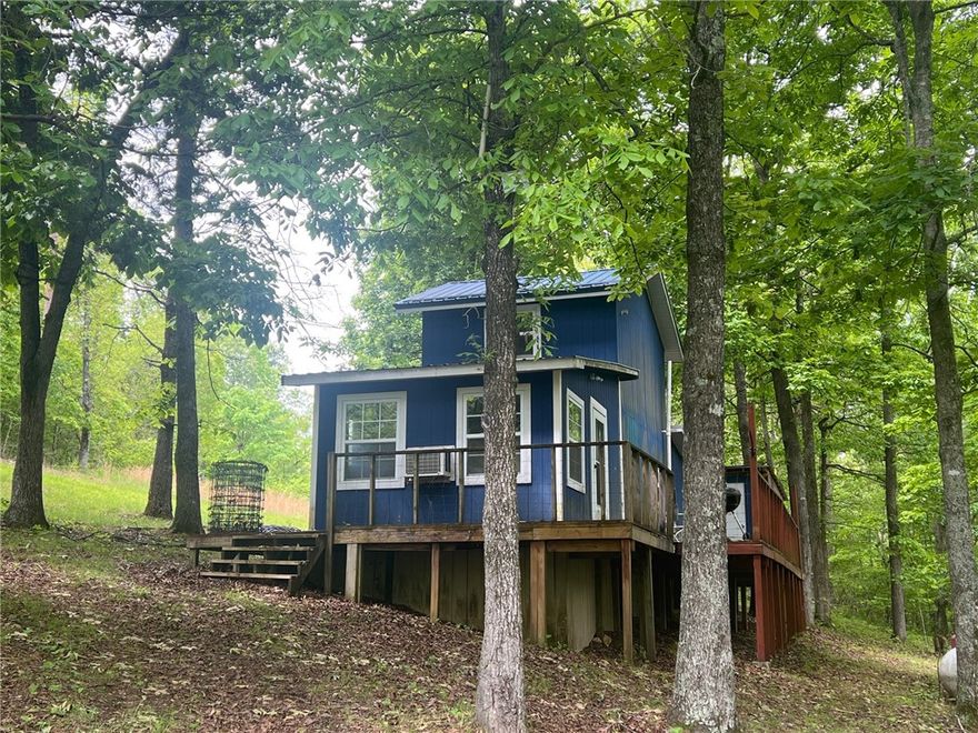 Cabin and 14.76 acres in the Marble Falls area of Newton County, less than a mile from the old Dogpatch and close to Hwy 7 but far enough away to feel secluded and private. With a little TLC this cabin would make a nice rental or getaway. Property has a drilled well and plenty of large trees with a seasonal creek. Great property to escape to for permanent living or a weekend retreat.