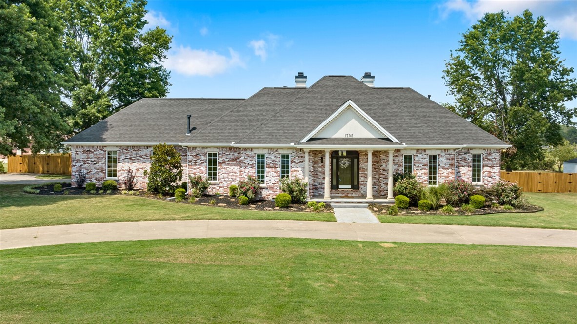 Hard to find 4,621 square foot home with pool & 600 square foot pool house on large 1.38 acres located in the middle of Rogers near I-49, restaurants, shopping, entertainment & walking/biking trails. This home features an open floor plan with 3 bedrooms on the main level, 4.5 bathrooms and 3 car garage. Large foyer open to Dining Room & Living Room with built-ins & fireplace. Updated eat-in Kitchen with island & bar open to hearth room & sunroom with wall of windows with views of the large backyard with pool & pool house. Large primary suite with sitting area & access to patio & bathroom with dual vanities, jetted bathtub & walk in closet. Upstairs enjoy a private bedroom with en-suite bathroom, game room & additional flex space. The outdoor space is completely private & perfect for entertaining; complete with covered patio, large flat backyard & heated gunite pool. 600 square foot pool house features large entertaining game room with kitchen & full bathroom with covered patio.