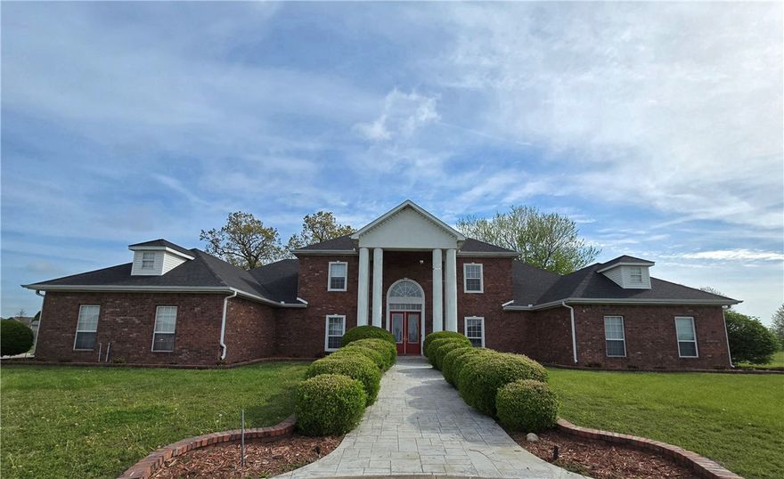 Well-built, estate-styled house adjoining the Tuscany subdivision. Unique location with over four acres! Has a beautiful statue in the center of the circle drive. Close proximity to Springdale schools, Fantinel Business Park, restaurants, and shopping. Just five miles from I-49! Has a heated in-ground pool with iron fencing around it and has been maintained by a pool company for the life of the pool. Contains leak sensors on all water lines for extra peace of mind. Has a storm shelter/safe room. Portions of the house were updated in 2018, including 3/4" oak flooring, new cabinets, and paint. Beautiful staircase located at the front of the home. Property has several fruit trees and grape vines!