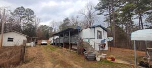 Over 5 acres of country living now available! Stay in the mobile while you build your new house or fix up the 30x40 building that is already there.There are 2 other outbuildings that convey. Fenced in yard, privacy, wooded and only 10 minutes to town! Call now for your showing!