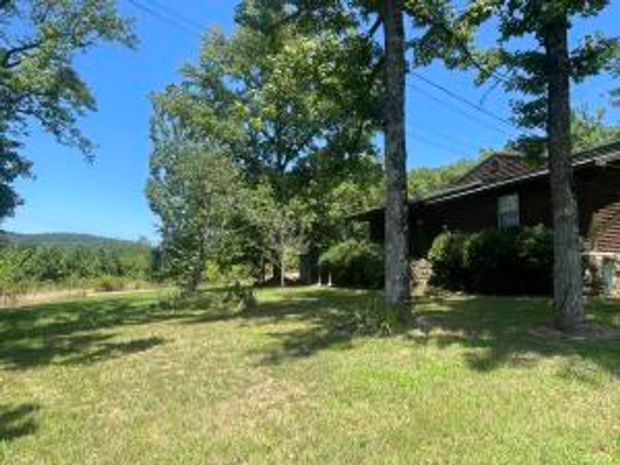 Serene location with National Forest surrounding you on 3 sides, this cabin-style home sprawled out on 4+\- acres offers a tranquil retreat with close proximity to Big Piney Creek, Pilot Rock, Graves Creek, and ATV trails. Providing an ideal vantage point to enjoy the sights & sounds of nature your large deck is perfect for outdoor gatherings or quiet moments of relaxation. 3 bedrooms, 2 full baths, and loft area! Whether you seek a permanent residence or a weekend getaway, this cabin-style home offers a perfect blend of rustic charm & modern convenience.