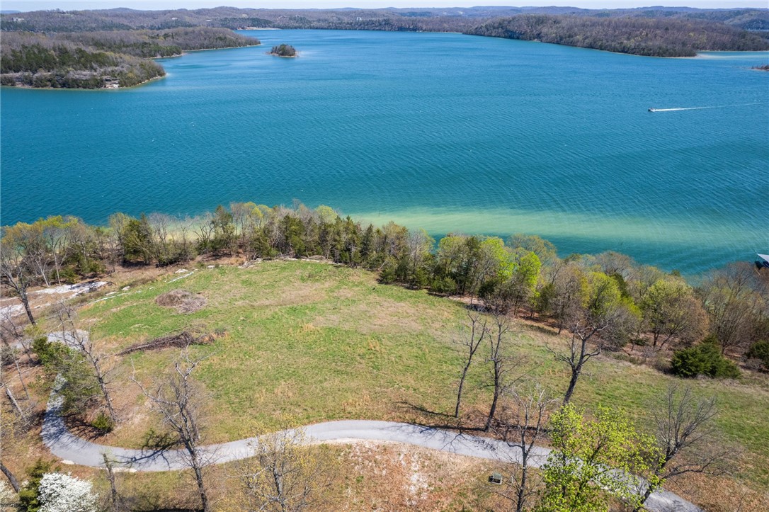 If you're looking for a buildable lot with the best views on Beaver Lake, look no further!
This incredible .26-acre lot, located in the highly sought-after Cotswold subdivision, offers sweeping, unobstructed lake views that are truly second to none. Nestled in a peaceful and private setting, it's the perfect spot to build your dream home or vacation getaway. The lot features a gentle slope ideal for construction, allowing you to design a home that takes full advantage of the stunning scenery. Whether you're enjoying your morning coffee or unwinding after a day on the water, you'll have front-row seats to one of the most breathtaking views Beaver Lake has to offer. With utilities nearby and easy access to the water, this is a rare opportunity to own one of the most desirable pieces of land on Beaver Lake. This property includes a boat slip in a co-owned boat dock. The dock is within walking distance from the lot and features a HydroHoist lift.