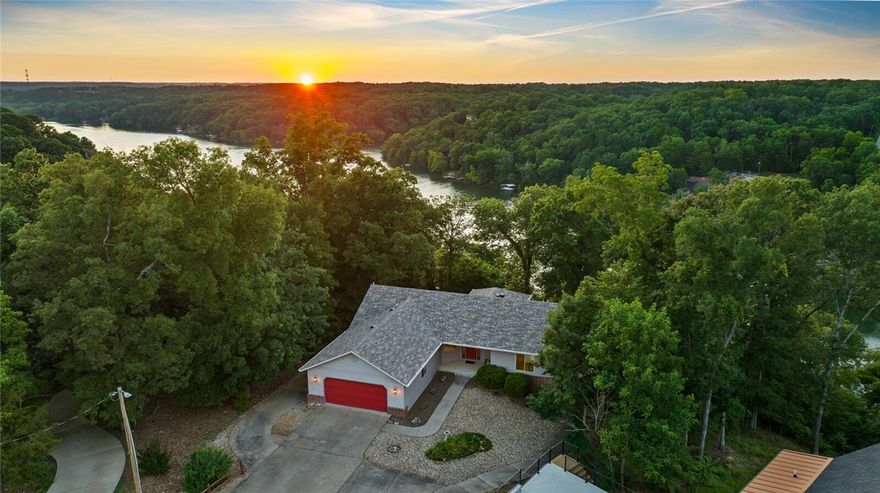 Take in stunning lake views every day from this 4-bedroom, 2.5 bath home perched above scenic Lake Ann. Built in 2001, this well-maintained property offers a spacious walk-out basement with a wet bar, abundant storage, and a dedicated workshop—perfect for outdoor gear or hobbies. Recent updates include a new roof and HVAC system, giving you added peace of mind. The backyard has been thoughtfully enhanced for low-maintenance enjoyment. Just minutes from the Back 40 mountain bike trails and Summit School, this is the ideal home base for outdoor enthusiasts who want the best of Bella Vista living with tranquil water views.