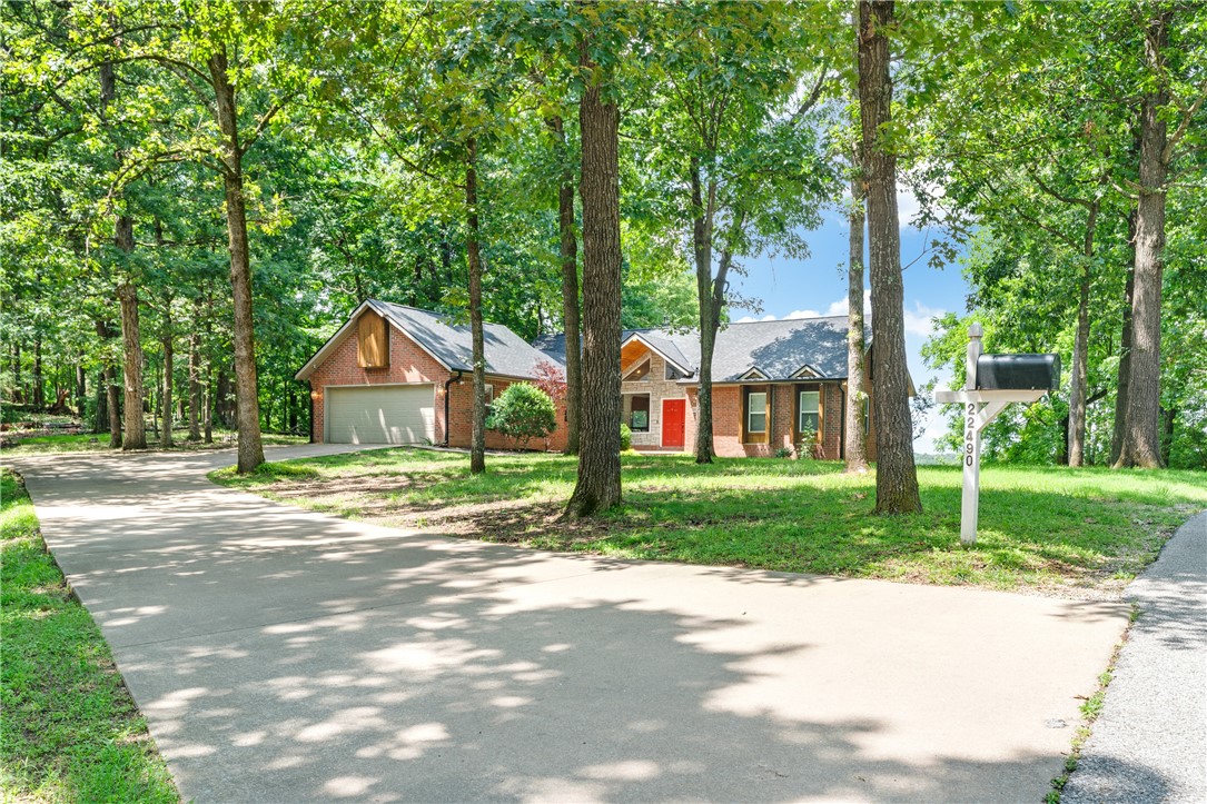 Rare 3.58 acre lake front home in East Springdale featuring 2 boat slips with lifts. This stunning property spans two parcels and is near the coveted War Eagle area on Beaver Lake—a true gem for lake lovers. The spacious 3,066 sq ft home offers peaceful water views and direct access to the shoreline. Home is complete with 4 bedrooms, 2 full baths, and 1 half bath along with 2 additional living area options downstairs. With expansive outdoor space and a serene setting, this is the perfect retreat for full-time living or weekend getaways. Properties like this—with land, privacy, and prime lake access—are increasingly hard to find! Plus, see if you can find the secret room. Check out the single parcel, 2 acre listing with 1 boat slip/lift at MLS 1312086 as well!