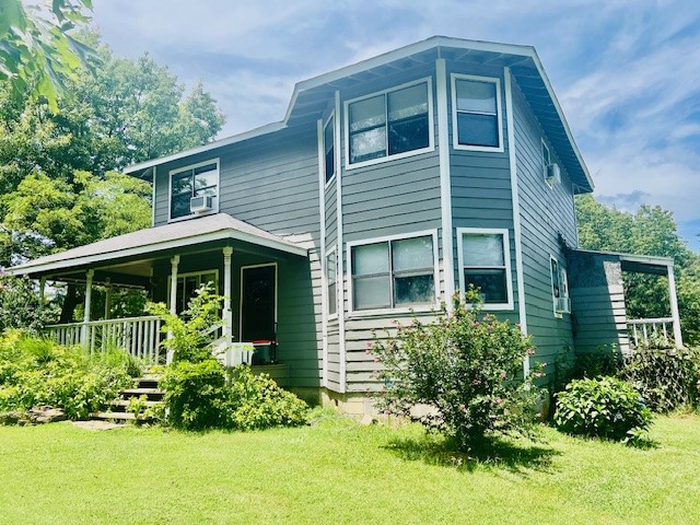 A pretty setting, where many Rose-of-Sharon blooms enhance the charm of this 2-story home w 2 bay-windows (built in 1990). Wrap-around porch and a covered back-porch are prime spots to enjoy the lawn and flower gardens. Made more private by a perimeter of woods, the house sits on 2.5 AC of level, cleared pasture which is fully fenced and cross-fenced. Spacious LR has added potential from nice custom pine paneling. To the right is a large room w bay-window, perfect for a potential formal DR in your future. Galley kitchen w a long counter has propane range, frig, DW. Half-bath w rustic paneling/tin ceiling, 2 pantries, and under-stairs storage complete the 1st floor. Wide stairway leads to upstairs MBR/BA w bay window. Another full-bath on the hall and 2 more BRs complete the 2nd level. 5 window AC units and 2 propane heaters provide heat & air. 2 outbuildings. 200 AMP service and 2 breaker panels. Potential attic storage with a plywood floor added.