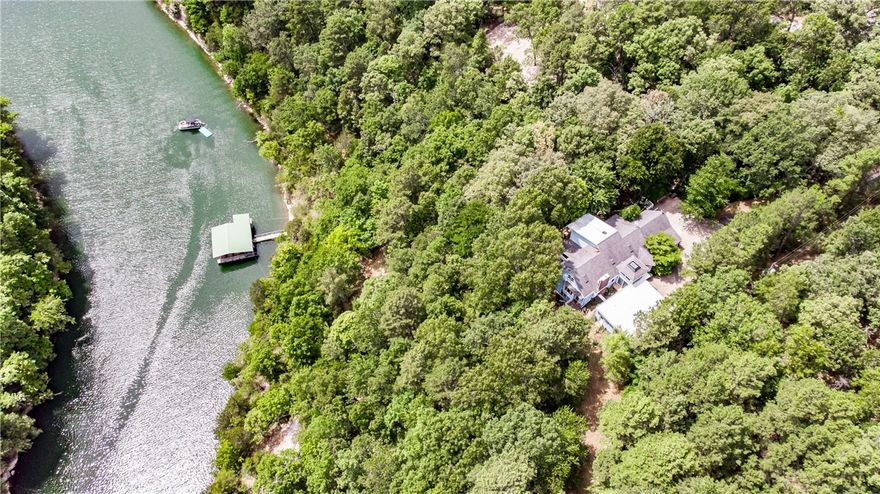 Lakefront home with a private boat dock! This spacious 4 bed, 4 bath home is a great opportunity for a vacation home or your dream lake home. This 0.76 acre tree studded lot offers plenty of space and privacy. Interior amenities include a large finished basement with kitchenette, master suite with ensuite bath, and beautiful eat in kitchen with stainless steel appliances. Spend evenings enjoying lake views from your oversized back deck with built in seating. The private dock will provide convenient access to your personal watercraft. Located in the serene setting of Beaver Lake yet only minutes away from all that Northwest Arkansas offers, this home is in an ideal location. Welcome to your dream home!