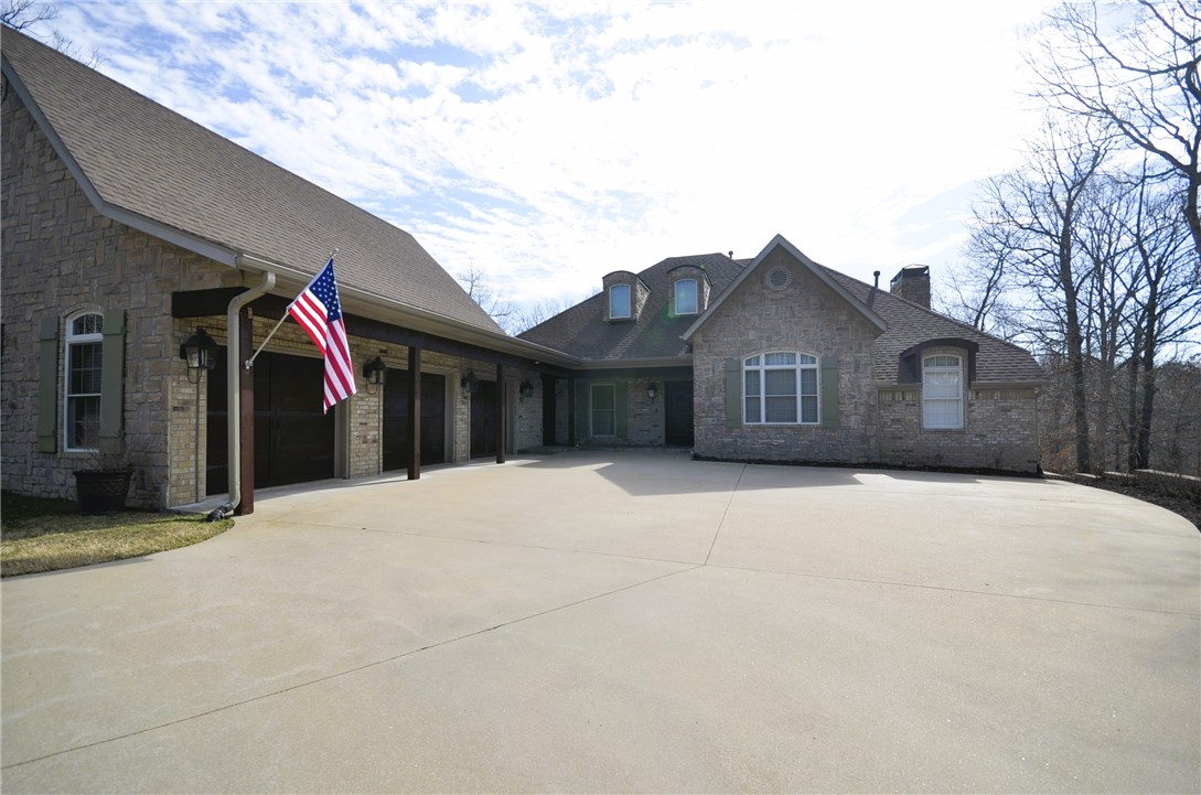 Don't miss out on this amazing opportunity to own this custom built home on 3-acres featuring a whole-house generator (2021), new roof (2021), new asphalt driveway (2023), storm shelter in garage, separate in-law/guest quarters, finished bonus room on 2nd level complete with full bath. Includes a private courtyard that's perfect for entertaining family and guests. It is also wired for a hot tub if desired. Inside, you will find a large kitchen complete with gas range and double ovens, spacious custom cabinets, granite countertops, large center island and walk-in pantry. The rock woodburning fireplace is the focal point in the living room with built-ins on either side. A wall of windows allow lots of natural light plus allows access to the covered back deck with wonderful wooded views. perfect for viewing the abundant wildlife. Above the 3-car garage there is unbelievable storage that is heated and cooled. Or use it for your private workout area. Don't let this one slip away, call me today for your private showing.