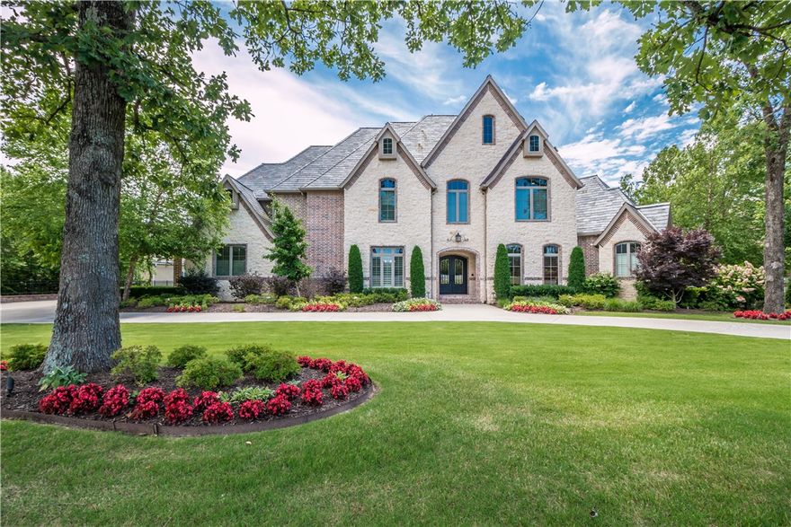 Stunning golf front estate located in the prestigious Pinnacle Country Club!  This immaculate custom built home offers 5 bedrooms and an inviting open floor plan with thoughtful design and layout.  Exceptional features including curved staircase, wine room, floor to ceiling windows, 4 living areas, 3 fireplaces and a gourmet kitchen with 2 islands!  The lower level boast a recreation room, kitchen, media room, exercise room, lower garage/storage and an additional en suite guest room.  Entertain or relax on the generous .81 lot offering lush landscaping, spacious deck & patios, sport court and enjoy the exquisite views of the golf course