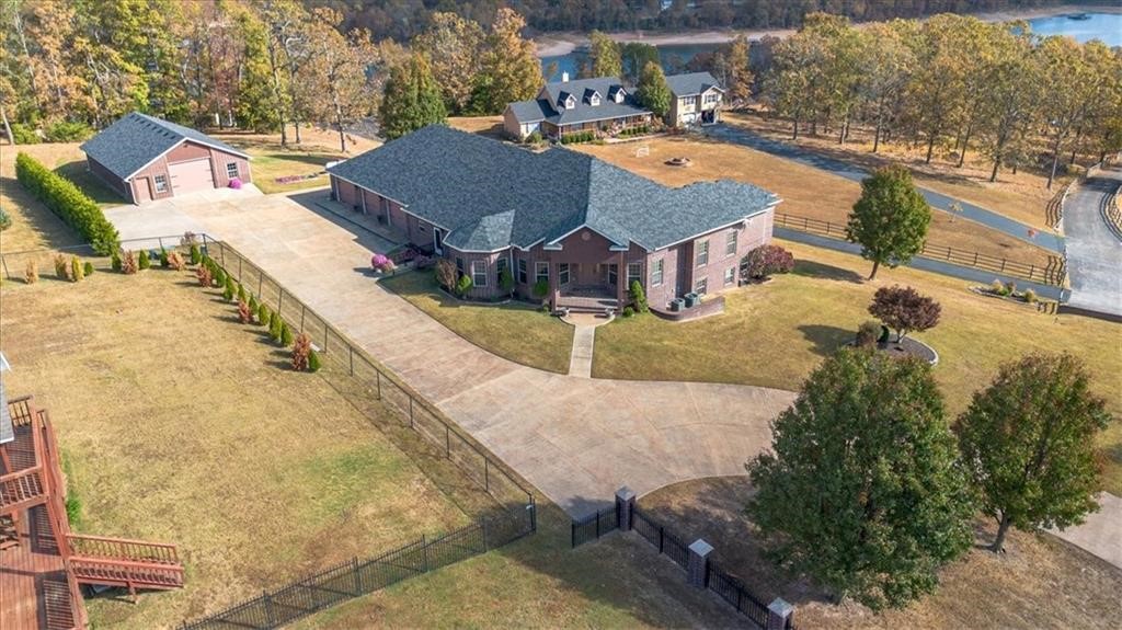 Nestled on 2.15 acres, this exquisite estate home on the coveted Monte Ne Cove on Beaver Lake exudes both luxury and relaxation! Whether you want to fish or swim off the private community dock(with boat slip/lift included), relax in the dedicated theater room, or enjoy your morning coffee on the beautiful veranda overlooking the sunrise on Beaver Lake - this home has everything you need! The spacious kitchen with top of the line custom finishes and large living room connected to the outside veranda, offer the perfect setup for indoor/outdoor entertaining of friends and family. Let's not forget the huge workshop! With garage doors on both ends, this building is perfect to store all of your trailers and toys or your latest hobby/trade. Whole home generator that conveys. All paved roads and less than 20 minutes to town. Perfect combo of lake living with convenient shopping/restaurants close by! View a special tour of this home here: https://vimeo.com/1100707636