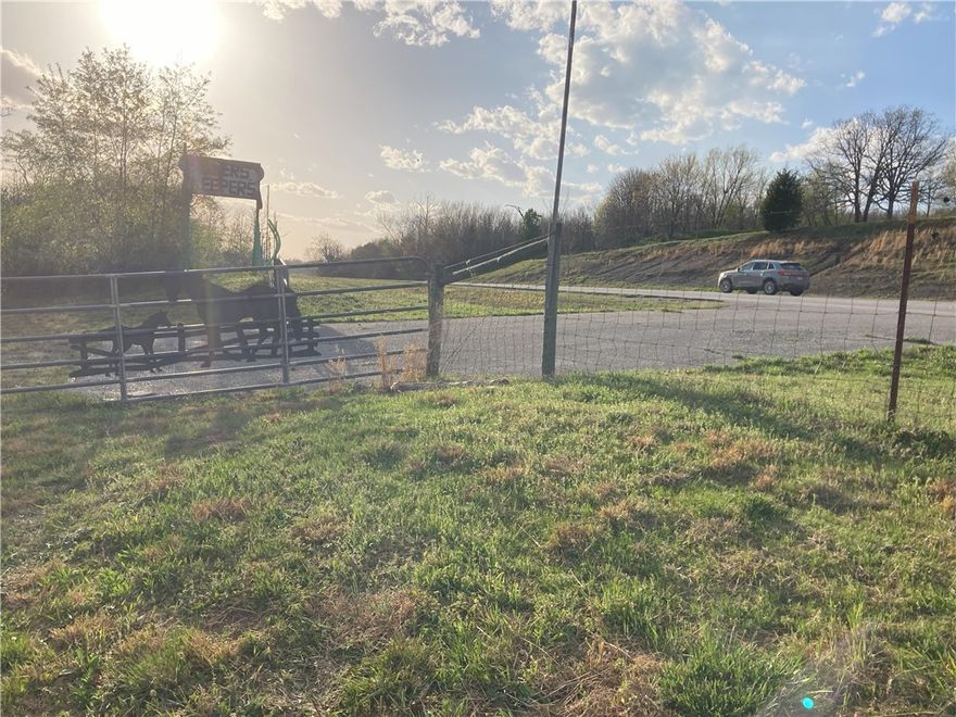 This versatile 6.57-acre property offers exceptional visibility with approximately 850 feet of frontage along Highway 412, just one mile east of the Highway 412 and Highway 21S junction. With a wide gated driveway already in place, easy access is a standout feature. The property includes a 960-square-foot building that has served as both a church and a flea market-style retail space, offering a flexible footprint for future use. An upgraded water well provides a reliable, high-quality water source, and the land offers ample space for expansion or development. Located just 3 miles east of the Kings River Country Store in Marble, this tract is ideally situated on a high-traffic corridor between Huntsville and Alpena, where daily traffic counts on Highway 412 average between 6,000 and 8,000 vehicles. The mix of road frontage, infrastructure, and location makes this a rare and valuable opportunity for commercial or mixed-use potential.