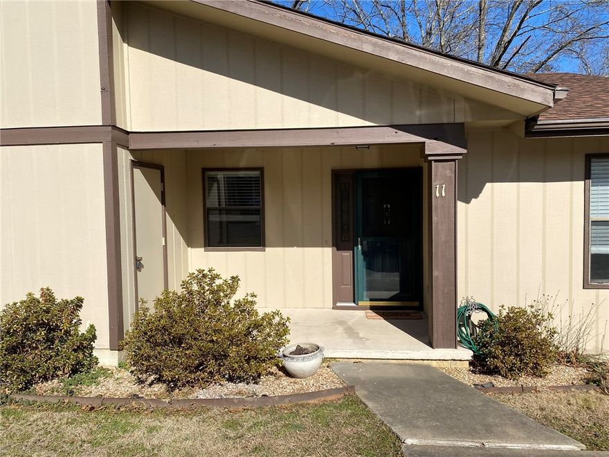 Welcome to this charming 2-bedroom, 1.5-bath, one-level townhome in desirable Bella Vista.

Freshly painted and move-in ready, the home features durable vinyl plank flooring throughout and an open living area. Sliding glass doors lead to a private back patio, offering peaceful wooded views with a glimpse of Dogwood Golf Course.

An outdoor storage shed provides convenient space for bikes, golf equipment, or seasonal items. Designed for low-maintenance living, this townhome is ideal as a full-time residence, weekend getaway, or rental investment.

Enjoy comfort, convenience, and easy access to outdoor recreation just minutes from Lake Brittany, the Back 40 Trails, and Blowing Springs Greenway.