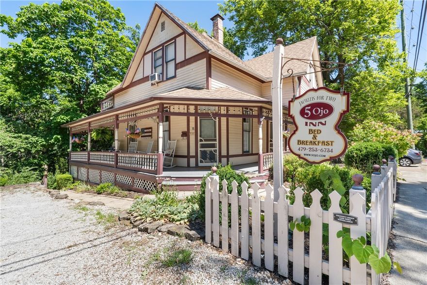 Own a piece of Historic Eureka Springs! This unique property features a main house of +/- 2,450 SF and a charming +/- 286 SF cottage, offering a total of 5 bedrooms and 5 bathrooms on a picturesque +/- 0.33 acre lot. Currently operated as an inn, this property presents versatile opportunities: continue running it as an inn while living on-site, or transform it into your personal residence with a guest cottage. Enjoy a serene and scenic setting with beautiful gardens, walking trails, and abundant wildlife. Conveniently located on the historic loop, this property has a trolley stop (red route, stop 97) right at the front, ensuring easy access to all of Eureka Springs. Additionally you're just a short stroll away from downtown, where you can explore vibrant shopping, dining, nightlife, and attractions! Don't miss this opportunity to own a piece of Eureka Springs' rich history!