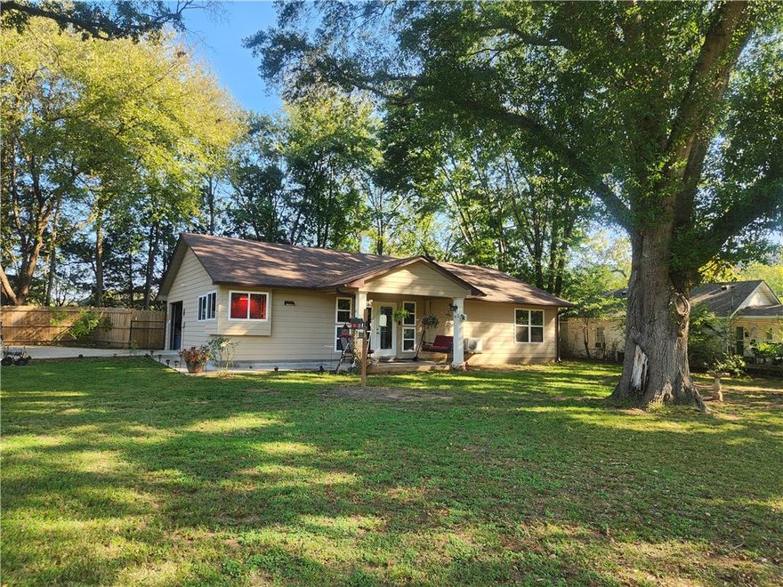 Country Comfort outside and Cowboy Chic inside, this custom built home is a charmer! Quality built for their personal home by experienced builders, this has everything you need! From the wood interior, the hickory cabinets in the kitchen, the big bedrooms, one with the potential to create a third bedroom, to the country front porch, and the back porch, to lots of deck space, this one has it all. Lots of beautiful extra touches, from the pocket doors to the wood look and feel of the tile floors. Super energy efficient, and lots more.  Completely fenced, in a private setting, this home includes a detached garage with a sink and a second room, The shop is set up with 300 amp service,  RV hook up and dump station.  so much more! Huge Oak trees, beautiful landscaped yard, lots of room for your pets.