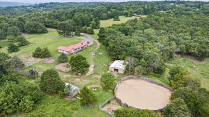 Nestled on 13 picturesque acres, this charming horse hobby farm offers the perfect blend of country living and equestrian amenities. The main home features 4 spacious bedrooms and 2.5 baths, providing ample space for family and guests. The property includes a well-maintained riding arena, ideal for honing your equestrian skills, and a barn equipped with 4 stables to comfortably house your horses. Additionally, a cozy guest house offers private accommodations, making it perfect for visitors or a caretaker. This serene retreat is a horse lover's dream, combining comfort, convenience, and natural beauty in one stunning package.