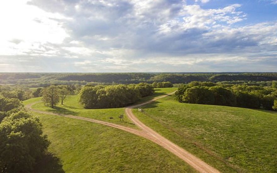 This 422 acre Ranch is located on the Arkansas/Oklahoma line at 25200 Ranch Rd, Gentry, AR 72734. Having 1.2 miles of the Spavinaw Creek makes this property a must see! Trout and other fish can be caught out of the creek on a regular basis and the creek gravel is readily available. The farms rolling hills give way to the beautiful bermuda grass creek bottoms. The pastures are divided into 10 separate paddocks to allow for rotational grazing. The 1516 Sq. Ft. house built in 2002 is a log home style having 2 bedrooms, 2 bathrooms and a very nice wood burning fire place. You will find all kinds of barns, outbuildings to store equipment, working pins, and even a roping arena! Deer, turkey, and other small game can be found on the acreage. This farm is as good as it gets with quality pasture, beautiful scenery, seclusion, and a Spavinaw Creek flowing through it!