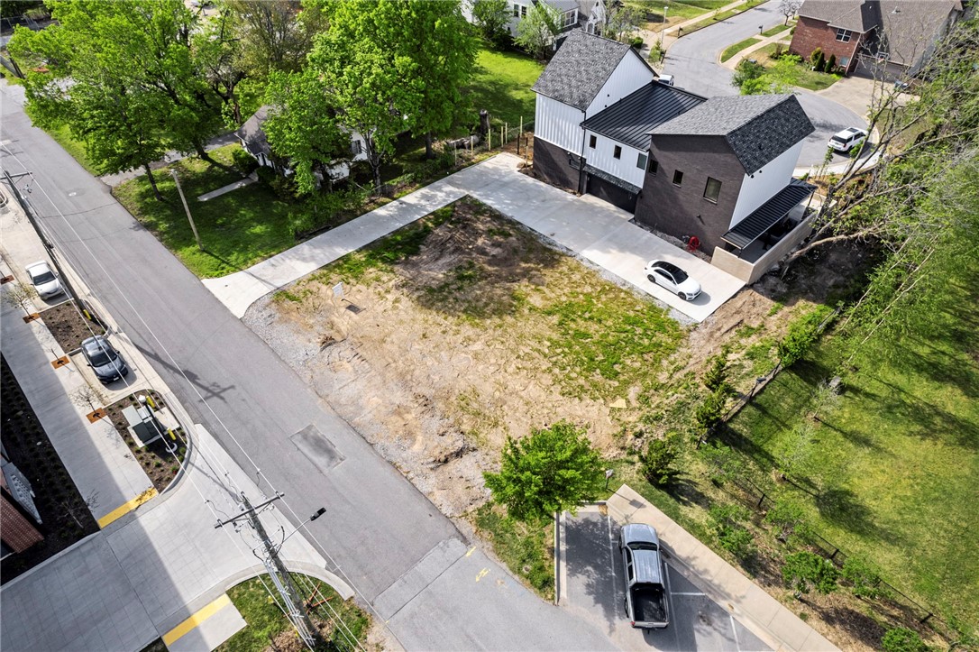 A rare opportunity to own a flat, ready-to-build lot with all utilities in place—no demolition required. Perfectly positioned between the new Walmart Home Office campus and the Downtown Square, this DN-3 zoned property offers flexibility for a variety of residential builds. Walk to The Momentary, 8th Street Market, and beloved local favorites like Meteor Cafe, Blu, and Walker’s BBQ—all within 5 minutes. Whether you're planning a dream home or investment property, this lot is one of the last of its kind in Bentonville’s urban core.