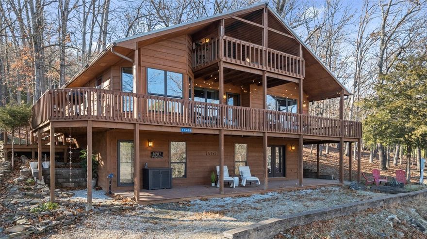 Lake retreat on a spacious 0.75 acre lot perfect for your personal home, investment and/or AirBNB! With seasonal lake views, multiple decks and nearby boat ramp, this Lost Bridge property brings the serenity of nature home. Walk into a large, open living space with beautiful, wood-burning fireplace & updated kitchen. The primary bedroom with updated bath, including heated floors, is located on the main level.  Upstairs is a private bedroom & bath plus an office or bonus area that leads right out to your own cozy, covered deck. The finished, walkout basement has a rec/mudroom with full bath and an additional bedroom/bonus room with pellet stove for those extra chilly nights!  The oversized, heated & cooled 3-car garage with half bath has more than enough room for all the toys (plus shed). Community amenities include pool, gym & pickleball courts!  Metal roof- 2016; SS appliances- 2019; water softener. Kitchen/garage refrigerators, Ring security system, and washer & dryer to convey.