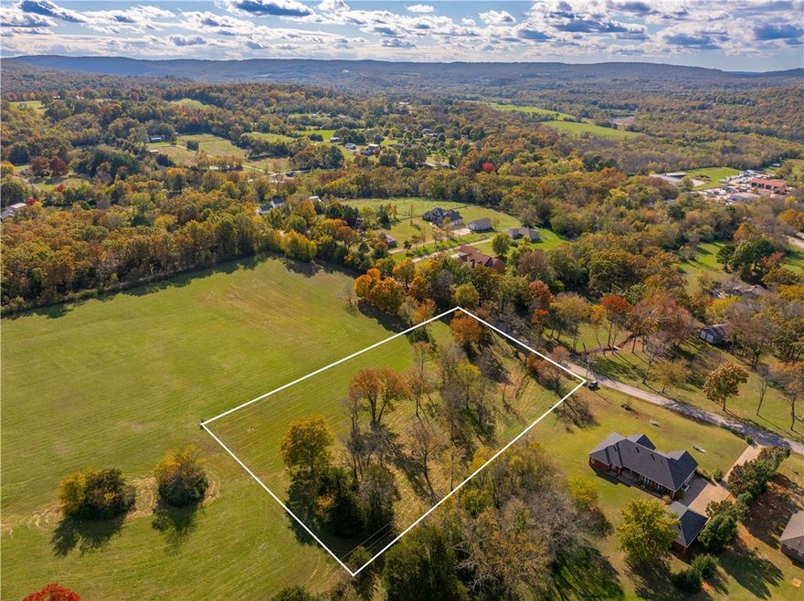 Spanning 2.42 acres, this beautiful lot offers generous room for your dream home, outdoor living space, gardens, maybe even a pool or workshop — plenty of freedom to design your ideal lifestyle. Quiet location but still convenient to Highway 71.
This parcel gives you that canvas. Enjoy morning coffee to the sound of birds, walk under mature trees, perhaps spot deer or other wildlife — country living at its finest, yet close enough to larger cities, like Fayetteville, AR.  Peaceful, quiet, with less traffic, less stress — a place to unwind after a busy day.