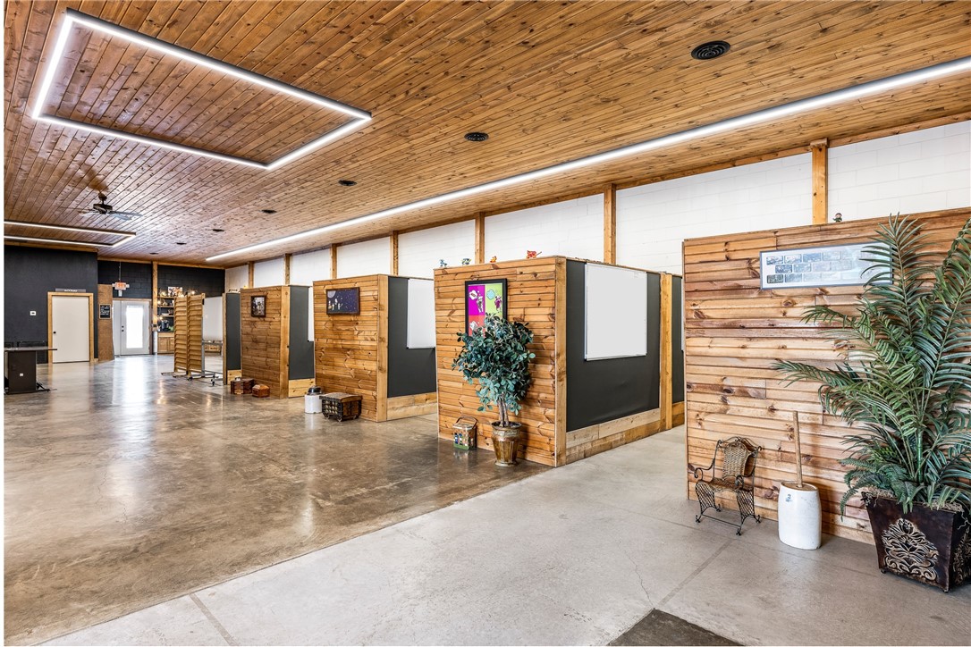 Located in the heart of downtown, this property has undergone a stunning transformation, blending cutting-edge design with a contemporary industrial feel. The interior boasts a bright & open-concept, featuring a handsome ceiling crafted from sustainably sourced wood, complemented by state-of-the-art overhead lighting creating a warm & inviting atmosphere! The open space is thoughtfully designed to maximize functionality while maintaining a modern, clean aesthetic. Yielding 3 private offices, a sitting area, conference space, multiple tasteful wood cubicles (can be removed), kitchenette, 2 half baths, one full bath & a large separate workshop. A great balance between private & communal areas, making it suitable for retail, office, or mixed-use applications. The outdoor fenced area features a multifunctional design - Take a lunch break or unwind after hours, shoot some hoops on the basketball court, fire up a grill, relax in the dining space, while enjoying the calming ambiance of an outdoor fountain. Truly a gem!
