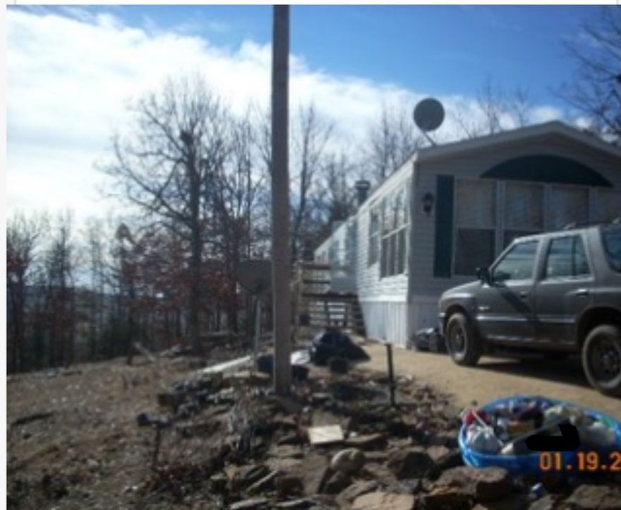 Well located 3.37 mostly wooded acres with a mobile home. Five minutes to Food and Fuel 20 minutes to Springdale area.