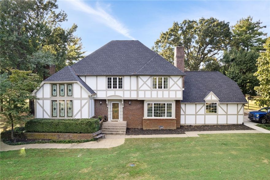 This listing encompasses a Main home, a Guest home, an in ground pool, and 5.22 Acres! This one has it all right in the heart of Centerton. Located just minutes to DT Bentonville but in a serene, park like setting with mature trees and gorgeous grounds. Welcome into your private gated entrance with a long driveway that leads up to your Tudor style home featuring over 4000 square feet. On the main floor you have a great room, office, sunroom, kitchen, formal dining, half bath and laundry. Upstairs you have 3 large bedrooms. The master suite has a large sitting area that couples as another office with an outdoor balcony. Don't miss the hidden bonus room above the master. Out back you'll find an in ground pool, 1117 sq ft guest house, and a 1704 sq ft workshop. Split rail fence around perimeter of property. Guest house would make the perfect mother-in-law quarters. You won't find anything quite like this! Large flat acreage at back of property would make a potential build site if you desire for additional family.