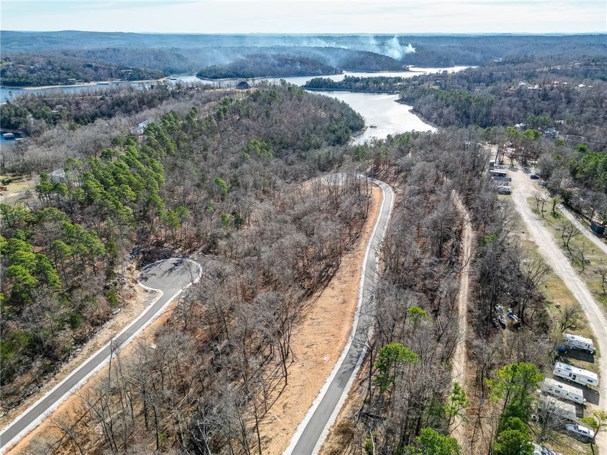 Discover the perfect canvas for your custom lake-area retreat in Blisslake, an exclusive new subdivision featuring only 9 premier estate lots w/dedicated community, lake front access. This 3-acre lot offers the ideal blend of privacy, natural beauty, & proximity to some of Northwest Arkansas' most sought-after amenities. Ideally located near Hobbs State Park, Rocky Branch Marina, the property is surrounded by endless opportunities for hiking, biking, boating, & outdoor recreation as well as just 20 minutes from downtown Rogers! The sloping terrain & serene wooded setting provide an exceptional backdrop for a luxury home designed to complement the Ozark landscape. Underground electric & water are available at the street, allowing for a visually clean, unobstructed setting. Blisslake is thoughtfully designed for those seeking a refined, peaceful lifestyle w/the convenience of lake access & nearby recreation, all within a private, high-end community. Build your dream home & experience the best of the Natural State!