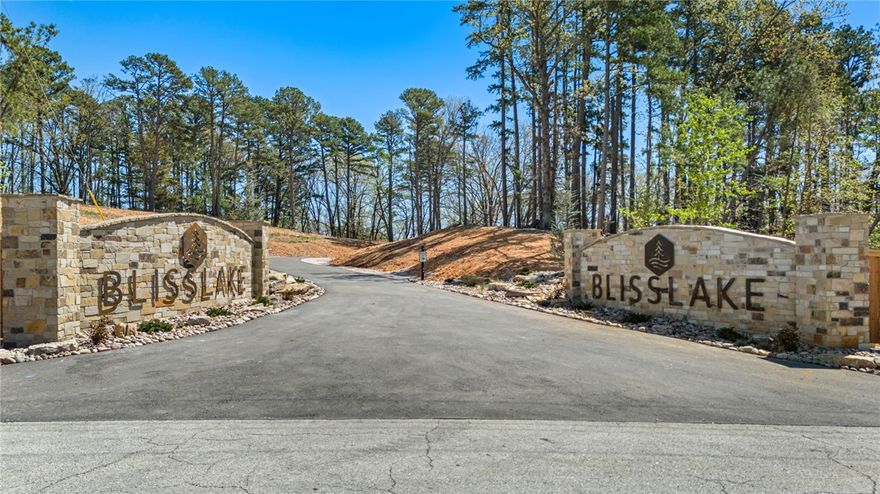 Discover the perfect canvas for your custom Beaver Lake area retreat at Blisslake, a new fully paved subdivision featuring 9 premier estate-sized lots with dedicated community recreation area and lakefront access for all lot owners. This 3-acre lot offers the ideal blend of privacy, natural beauty, & proximity to some of Northwest Arkansas' most sought-after amenities. Ideally located at the Northern end of Beaver Lake near Hobbs State Park & Rocky Branch Marina, the property is surrounded by endless opportunities for hiking, biking, boating, & outdoor recreation as well as just 20 minutes from downtown Rogers! The sloping terrain & serene wooded setting provide an exceptional backdrop for a luxury home designed to complement the Ozark landscape. Underground electric & water are available at the street, allowing for a visually clean, unobstructed setting while streamlining the building process. Build your dream home & experience the best of the Natural State!