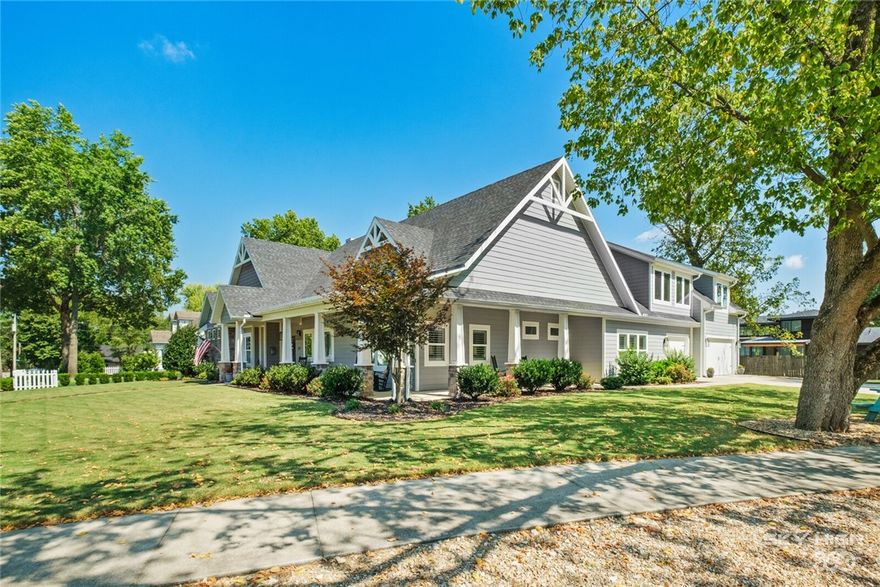 Downtown Bentonville lovers...don't miss this opportunity! Corner .47 acre lot within walking distance for all things downtown Bentonville. Home was designed with a focus for those that enjoy hosting and entertaining. Views from the living area out to the patio and pool are matched by the views from outside back into the living area. Upstairs offers it's own guest suite, which includes sitting area as well as office space in a completely private space for guest. Master suite is split from the remainder of the house also providing privacy. Office/TV room off of the main living area provides flexibility to what works for best for any family. Kitchen/dining area includes 9' island that's great for those gather in the kitchen conversations that are typical of most gatherings. Wrap around front porch accents the corner lot appeal. Back patio is partially covered and partially open creating a unique space complete with dual refrigerators, gas starting fireplace and natural gas grill that never needs tanks refilled.