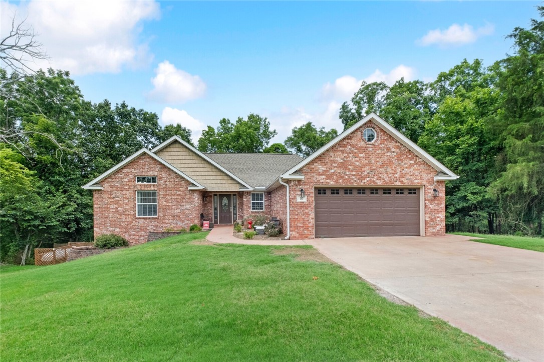 Nestled in a cul-de-sac just 15 minutes from downtown Bentonville surrounded by bike trails, Sugar Creek, golf courses, Bella Vista lakes, and all the outdoor activities NWA has to offer. This charming two-story residence is the perfect blend of relaxation and convenience. Step inside this well-maintained home to discover a spacious layout designed for effortless living & entertaining. Upstairs, you'll find 3 bedrooms & 2 full baths. Imagine unwinding on one of the multiple decks overlooking the backyard and woods or enjoying bug-free evenings on the screened-in porch. Downstairs, provides a 4th generously sized bedroom, bath & living space. Whether you're looking to host gatherings with friends or simply enjoy the quietude of your own sanctuary, this home provides the perfect canvas. Large storage area under the home!
