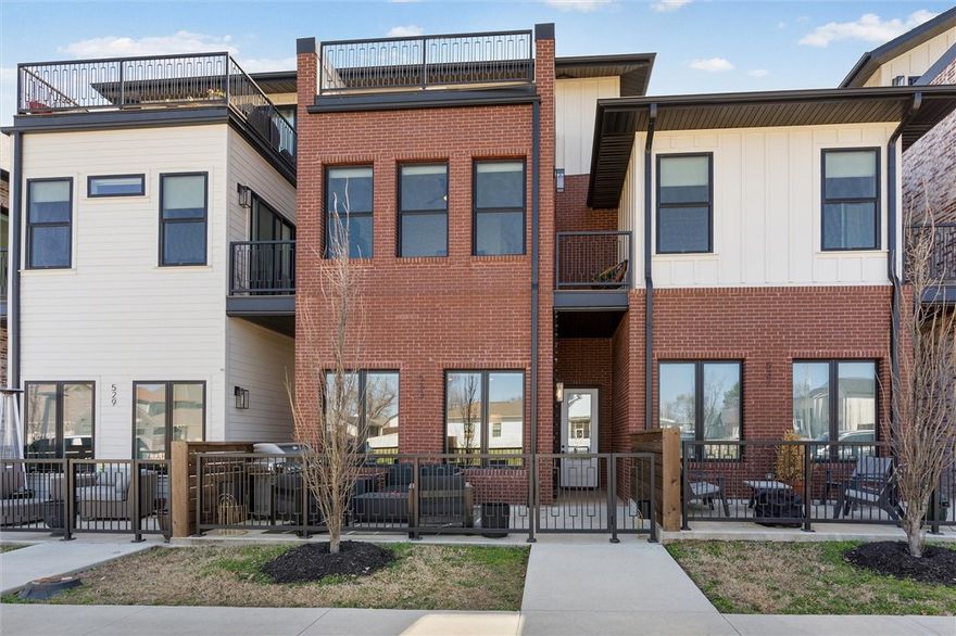 If you want to be able to walk to dinner, a movie, shops or ride trails this townhome is close to it all yet private and quiet. This large townhome is almost 2,400sf with great entertainment space including 3 separate patios, open kitchen with beautiful tile backsplash and open shelves, great guest rooms on the 2nd floor with attached bathrooms. Owner has entire 3rd floor as primary suite, and it does not disappoint with the oversized bedroom with sitting area, large private roof top deck and huge bathroom with walk in shower. The local art, wallpaper in powder bath and new light fixtures really makes this townhome stand out. Garage is large enough for 2 cars or a car and plenty of toys. Come see why this townhome is the perfect space to enjoy downtown Bentonville. Easy to maintain and lock up and leave as well. This townhome is a must see if your wanting to live the luxury life in downtown Bentonville.