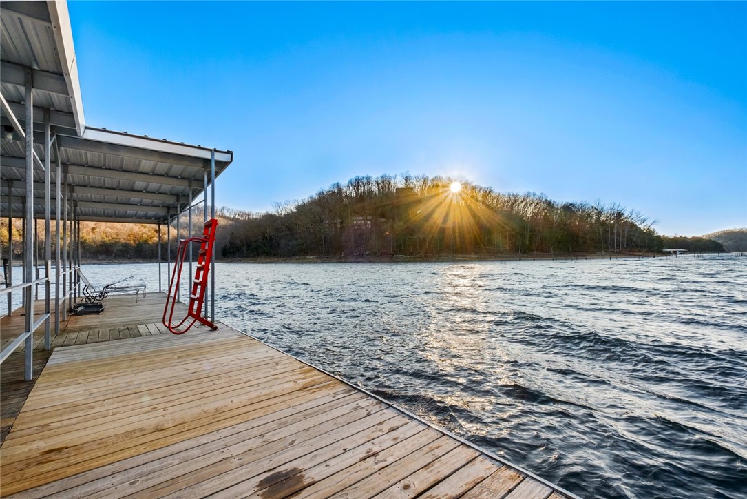 MOTIVATED SELLER!
Picture it: Beaver Lake 2026.
You wake up in your newly built home on the incredible 1.55 acre lot you purchased in 2025. You look out at the gorgeous, expansive view over the lake and pinch yourself. You ponder your options:
Do you hit the lake from your boat thatās waiting in the boat slip that conveyed with the lot? Youāre a short ride to Starkey, Hogscald or party cove!
Or go for a swim and float off the community dock in the beautiful, calm deepwater cove?
Do you rent it out for the weekend to recoup expenses? STRs allowed and renters can swim off the shore or put a boat in at Big Clifty ramp, 5 min away!
Do you travel down the road for a fun afternoon in downtown Eureka Springs? Itās a gorgeous little paved drive.
Or visit with your lovely (but not too close) neighbors and take a golden hour cruise? Thereās a great mix of full-time and part-time residents, adorable cabins and larger upscale homes.
The possibilities are endless and you really have to see it for yourself!
