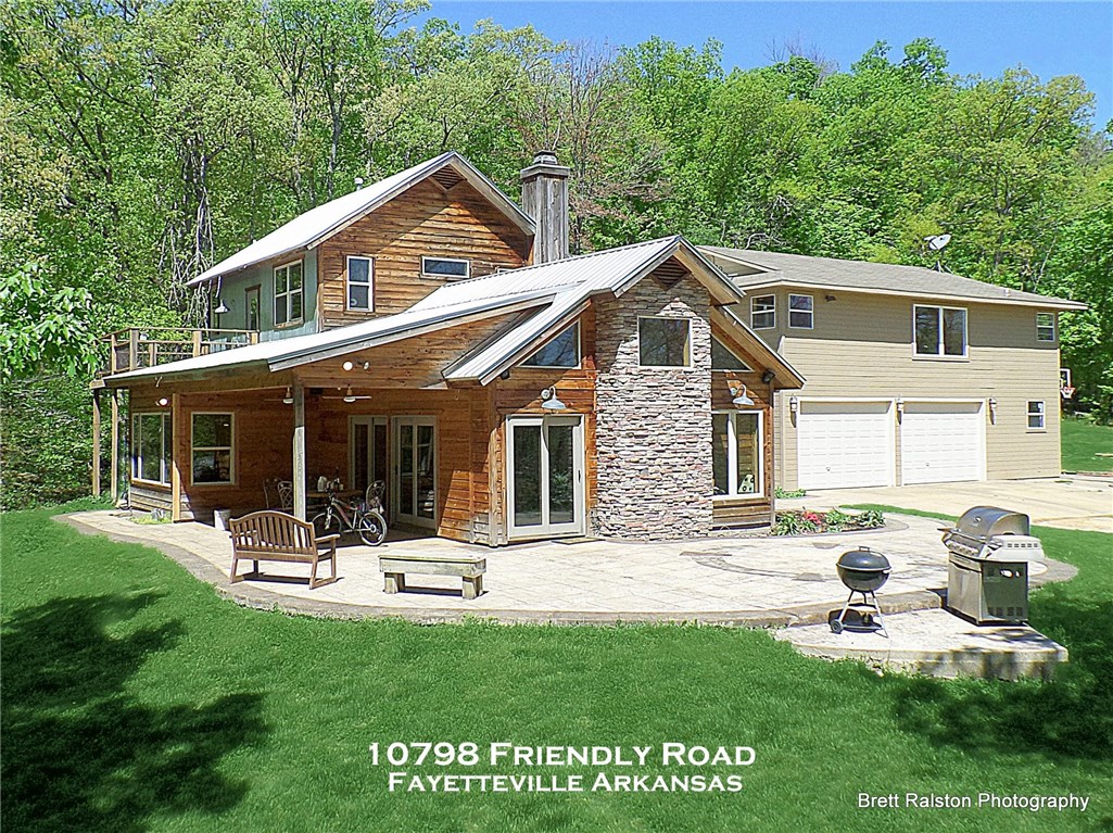 Unique Rustic contemporary home with extraordinary views of the one acres spring fed lake. This home features 2 full kitchens, 2 laundry rms, two upper decks, 2 patios and a breeze way. Beautiful Pine walls, stone fireplace, lots of natural light, open floor plan, vaulted ceilings, high speed ceiling fans, stained concrete and cork flrs, sinks built into the showers, SS counters, ample storage, recessed lighting in MBR. MBR also has its own private patio. Built in surround sound. A 20 acre Private Oasis!