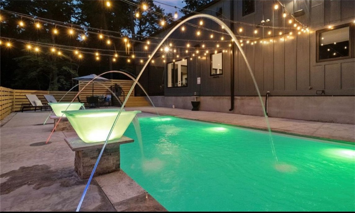 This stunning Beaver Lake Short Term Rental home is the perfect getaway retreat only 10 minutes from Downtown Rogers and a minute's drive to Beaver Lake. This STR rental comfortably sleeps at least 16 people with 2 master bedrooms on the main floor and media room with 6 bunk beds on the top floor. A beautiful private outdoor swimming pool, hot tub, 2 living rooms with a double fireplace, and huge screened in porch are just some of the amenities that go with this property. This property should easily gross $100k a year. If not used as a STR this house could be the main house with 8787 Falls Hollow (also for sale) used for a guest house.