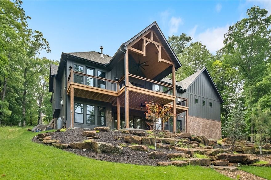 Welcome home to Blowing Springs—a beautifully crafted home offering direct trail access to the Blowing Springs Trail system from your own backyard. Tucked into a quiet Bella Vista setting, this property is ideal for those who love the outdoors but crave refined living. And with a 12-minute drive to Downtown Bentonville with no stoplights, you’re never far from the heart of Northwest Arkansas.
Enjoy 12-foot ceilings, a dramatic stone fireplace, and an inviting floor plan that includes two primary suites—one on the main level and the other in the walkout basement—offering privacy and flexibility. The lower level also features a kitchenette, wet bar, and a dedicated bike storage room that opens directly to the spacious, landscaped backyard with firepit and hot tub.  Additional features include a private study, safe room, oversized garage, irrigation system, and furnishings that convey. This is a rare opportunity to own a move-in ready retreat where modern comforts meet nature—right in the heart of Bella Vista.