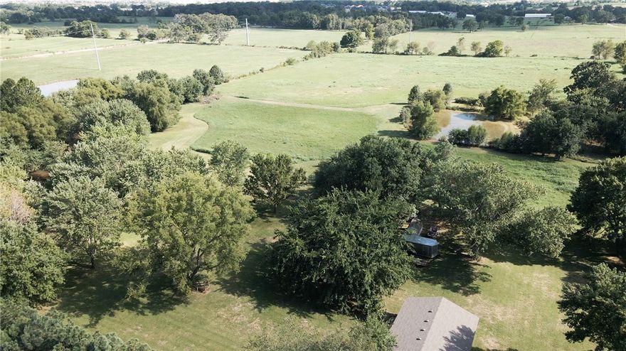 Great acreage property near Centerton New Downtown Center! Future use plan for the property is multi-family. Property has two ponds. Land is mostly cleared with trees around home and ponds. There is a well on the property but the home is on city water. Shop building on property that is 1,200 SQFT. Great for buyers looking for acreage with a home or developers wanting land near future growth. Home is on septic but sewer is at the street.