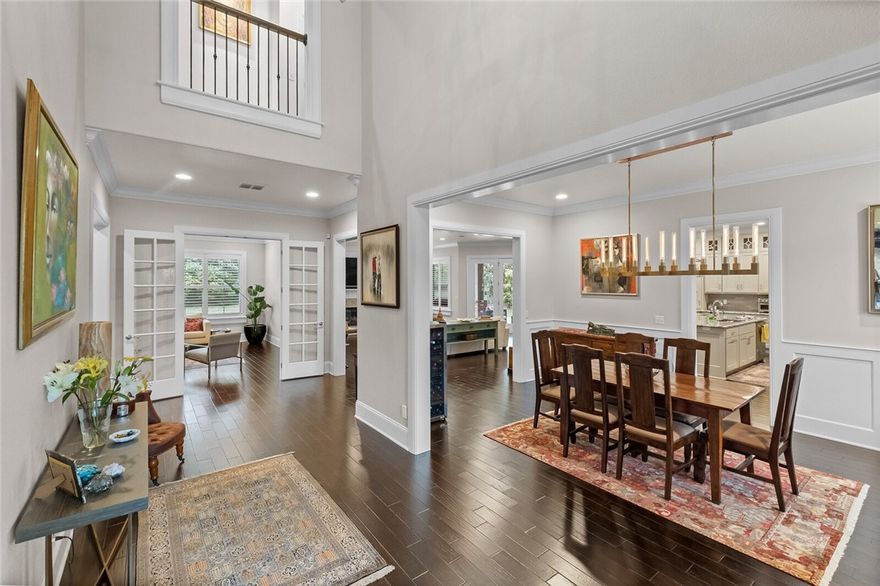 Enjoy luxury living in NWA’s prestigious Pinnacle Country Club. This elegant, 2014 built, contemporary home features an open split floor plan, rich ebony hardwood floors, plantation shutters, designer lighting, entire home surround sound system, French doors, crown molding, beautiful fireplaces, vaulted ceilings, and so on. Five en-suite bedrooms, primary and guest suites on the main floor together with office, formal dining room, powder bath, spacious family room that opens up to the dream kitchen with recently painted cabinets, granite counters, oversized island, Wolf/Sub Zero appliances. Two custom built closets and a luxurious bath enhance the beauty of the owner’s suite. Upstairs, you will find 3 bedrooms, 3 baths, and a home theater with a 110” screen projector system along with a wet bar with a fridge. Zoned for Bentonville and Rogers schools. Half an acre professionally landscaped yard with flat backyard ideal for a large pool/spa to make an outdoor retreat of your dreams. Welcome home!