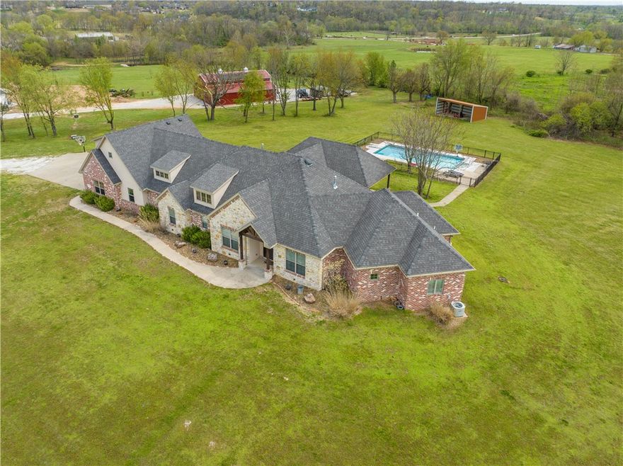 Public remarks: Centrally located in one of the more desirable area's in all of NWA. This home checks all the boxes with acreage, Large open floor plan, elite schools, privacy and serenity that makes this property one of a kind. This one level, one owner home built in 2015.
Includes 30k gallon swimming pool, bonus room, safe room, office, functioning dining room. 4 bedroom with 4 bath, 4492 sq ft of living space, shed and 4.87 acres of privacy. Home has a Rain soft purifying system and filter. Click on link for flyover viewing.