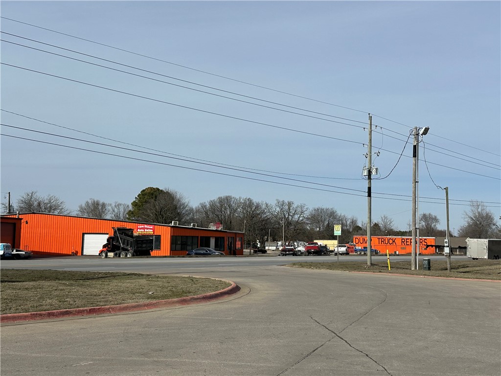 Warehouse-Service Center-Showroom-Office with Fenced Yard and 2 points of truck access from NE Hudson (Hwy 62). The location and flexible suite & yard combinations make this the perfect property of truck/auto service, equipment rental/service, boat dealership, construction company or light manufacturing and assembly. SEE MARKETING FLYER WITH FLOOR PLAN ATTACHED FOR MORE DETAIL.
Two buildings on a total of 2.9 acres, fenced. Primary building includes two contiguous suites of 6,720 + 10,280 sq ft = 17,000 sq ft total. A separate Outbuilding of 2,400 sq ft with drive-thru roll up doors, perfect for Truck service.
City of Rogers Zoning T5.2 Commercial designation allows multiple permitted commercial uses include auto service, entertainment / event venue, retail sales, food / beverage.