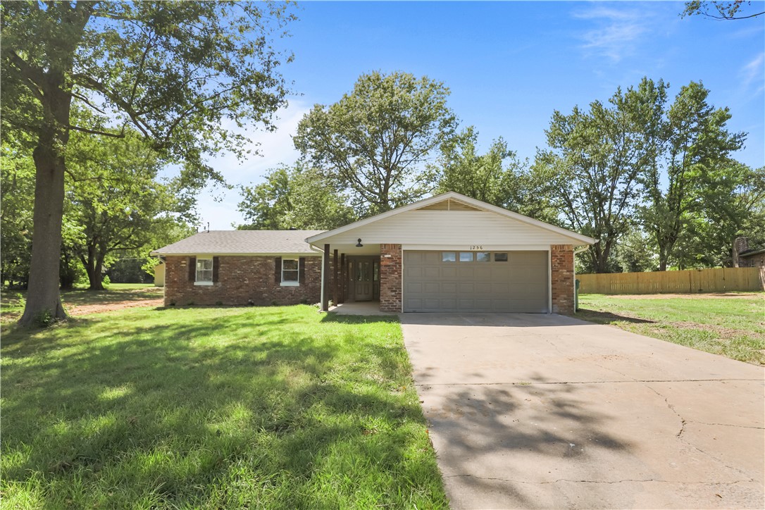 Tucked away on a private, partially wooded acre, this beautifully updated home offers peaceful seclusion just minutes from all the amenities of west Springdale. Inside, youāll find new luxury vinyl plank flooring throughout, fresh paint, stylish light fixtures, and a warm, inviting layout. The kitchen features quartz countertops, freshly painted cabinets, and a brand-new oven. Both bathrooms have been fully renovated with quartz counters, tile flooring, and updated fixtures. The spacious primary suite includes its own cozy fireplace and a stunning en suite bath with a tiled walk-in shower. Outside, enjoy a low-maintenance, all-brick exterior, new roof, new outdoor AC unit, and a brand-new septic system. The large, flat lot is ideal for outdoor living, and the 550 sq ft detached shopācomplete with electricity and a separate gravel driveāadds versatile space for work or hobbies. A rare combination of privacy and convenience!